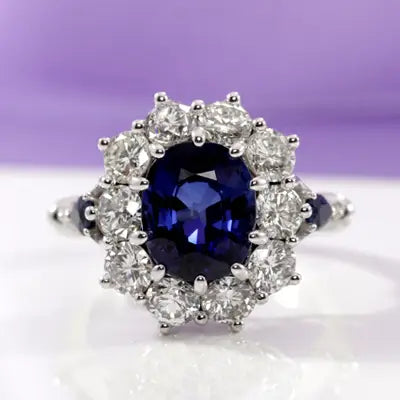 custom designer blue oval sapphire halo with alternating diamond accents