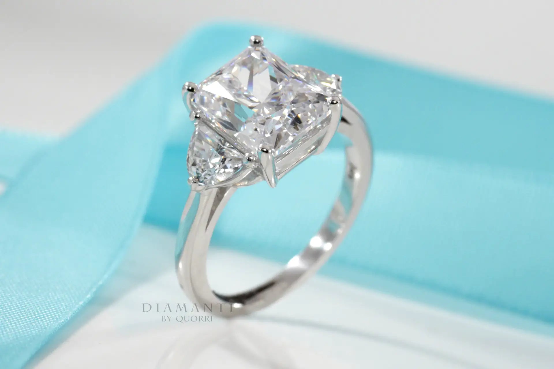designer three-stone radiant and half moon lab diamond engagement ring Quorri