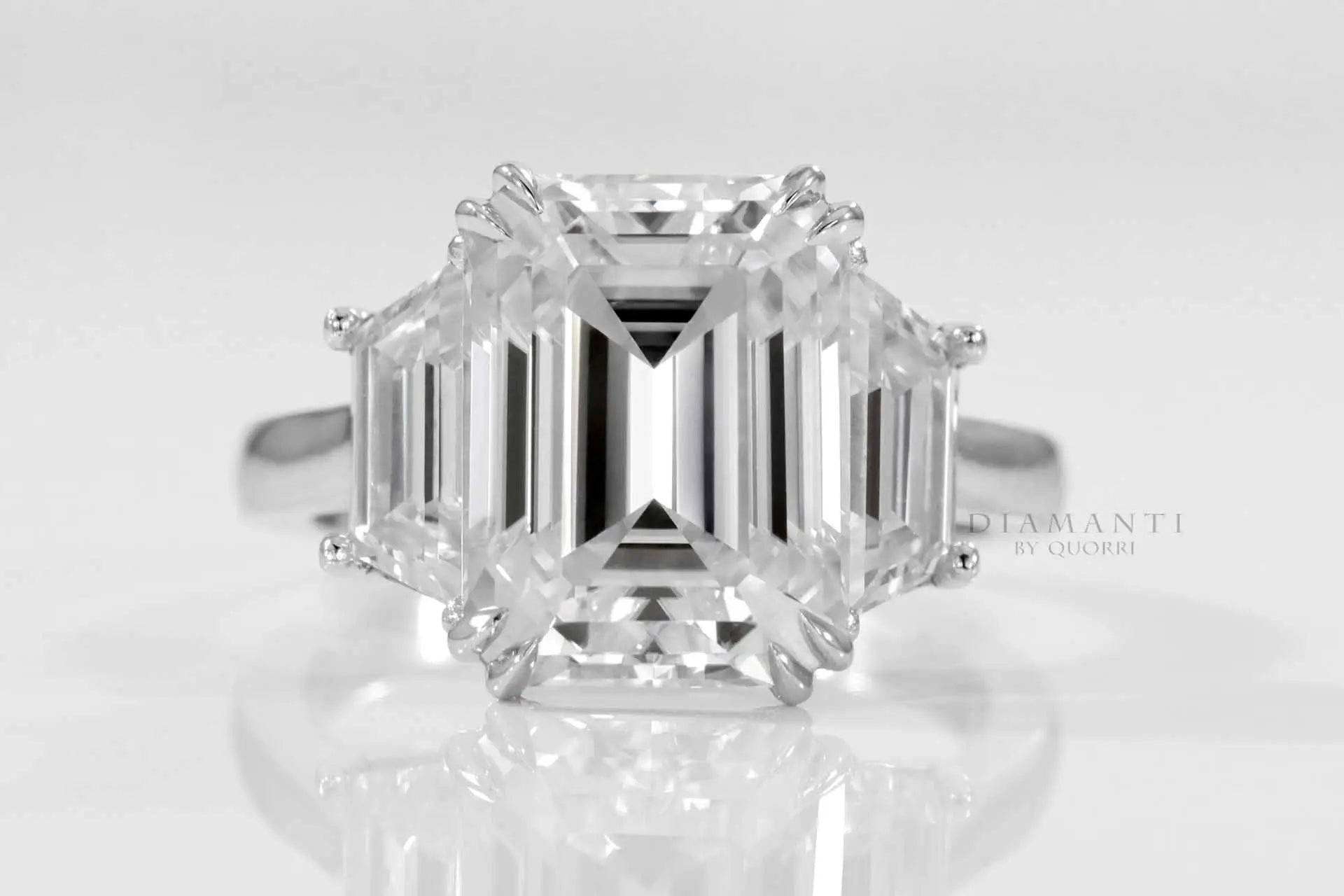 dual claw emerald and trapezoid three stone lab diamond engagement ring quorri
