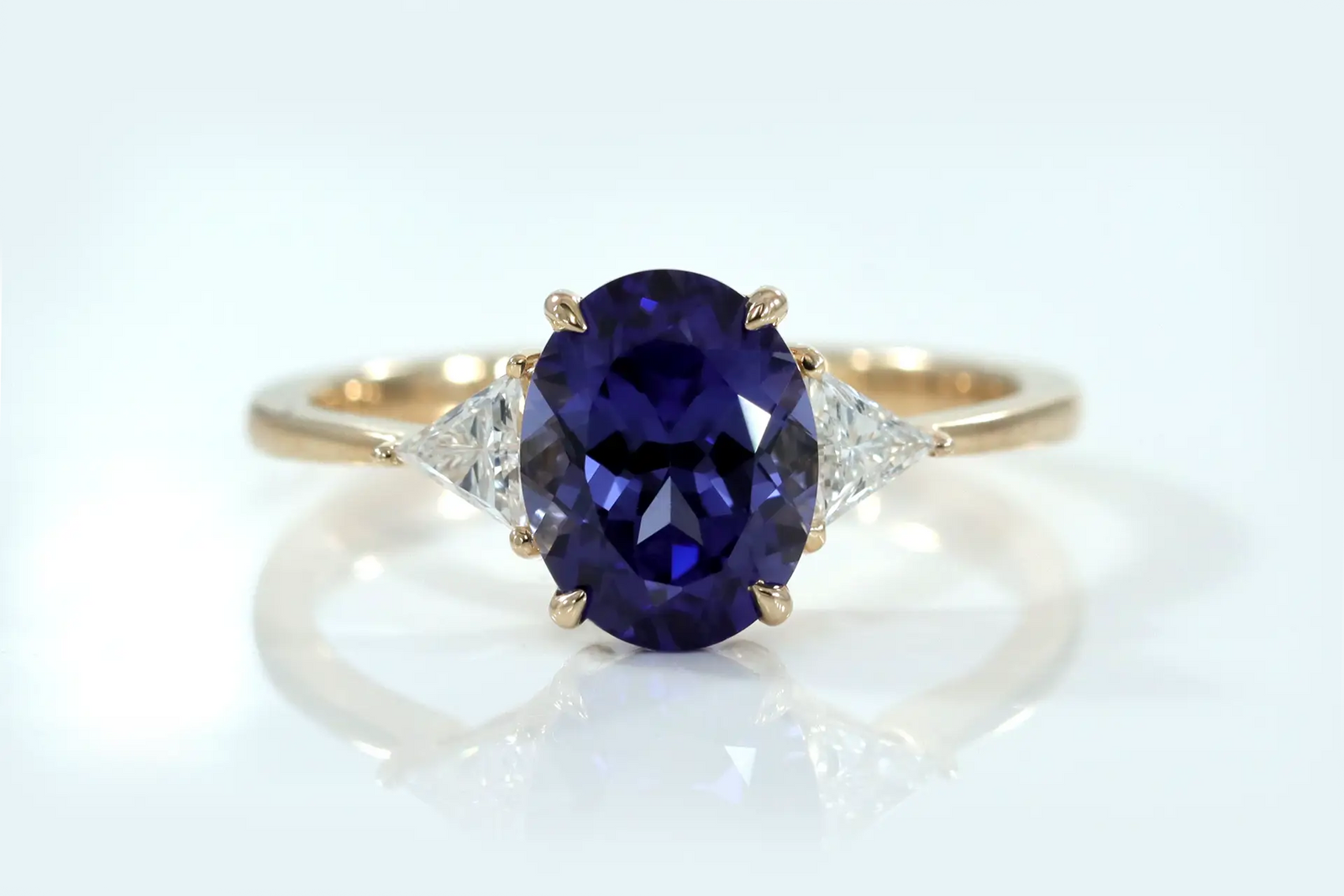designer three stone 2 carat oval lab grown tanzanite with lab diamond triangle sides engagement ring Quorri