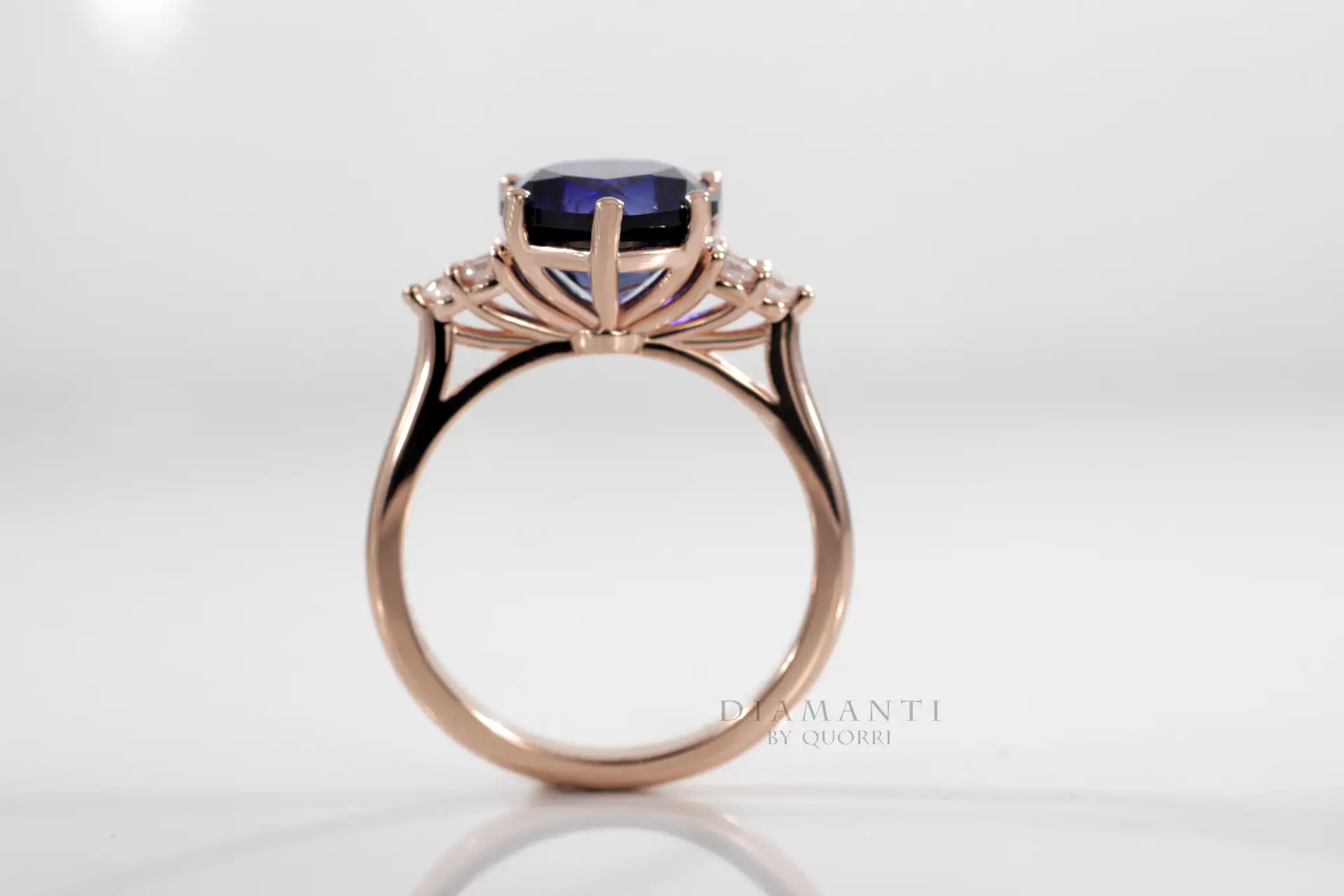 custom rose gold 6 prong 3.5ct pear cut lab grown blue sapphire engagement ring with round accents Quorri Canada