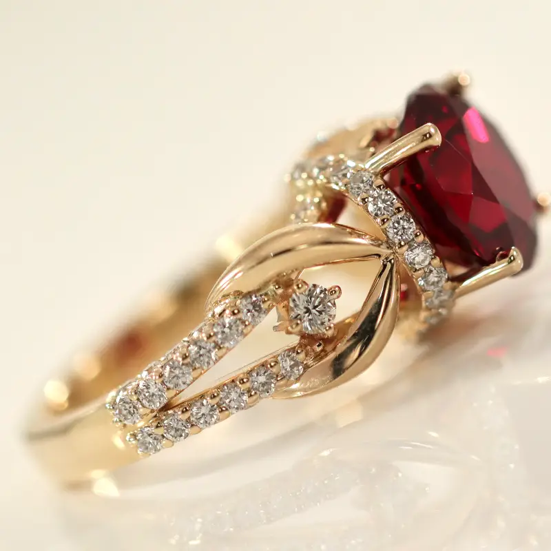custom blood red round ruby with white diamonds in 18k yellow gold setting