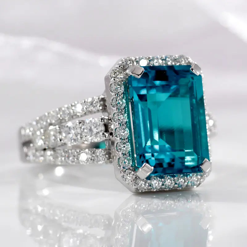 emerald cut Zambian green emerald three row accented halo ring