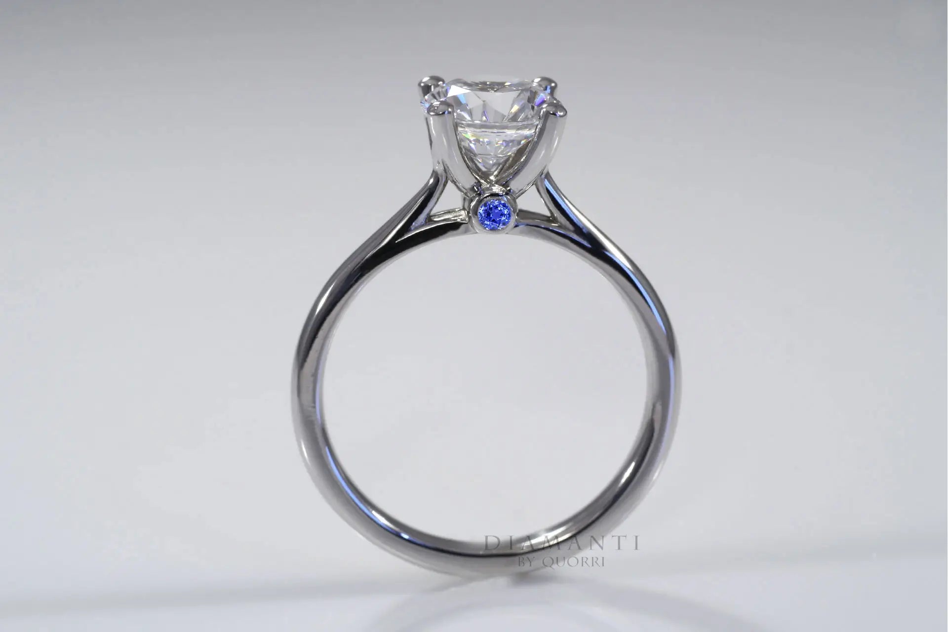 white gold round lab diamond with blue sapphire front accented solitaire ring