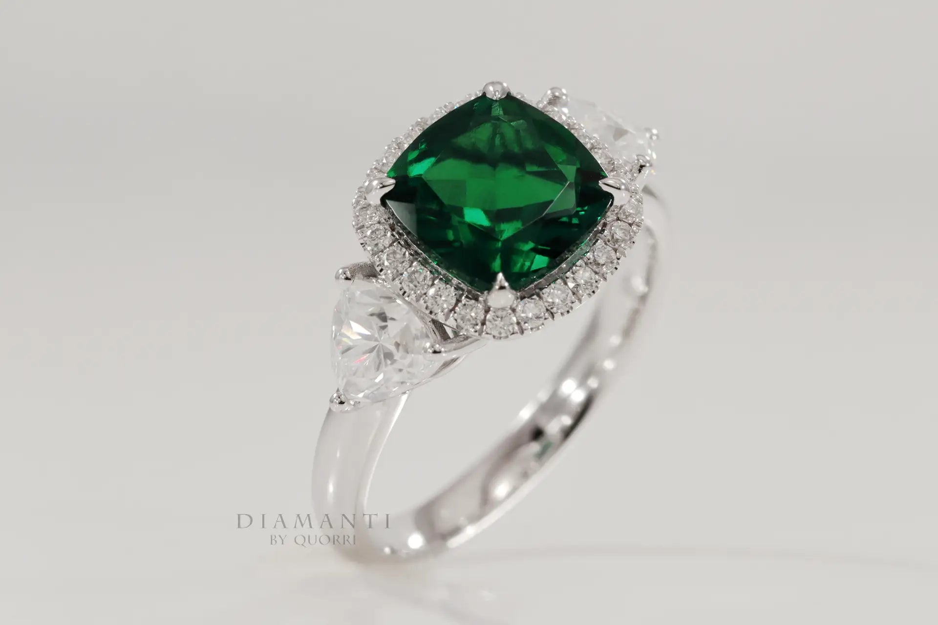 designer three stone green emerald and trillion halo diamond engagement ring Canada