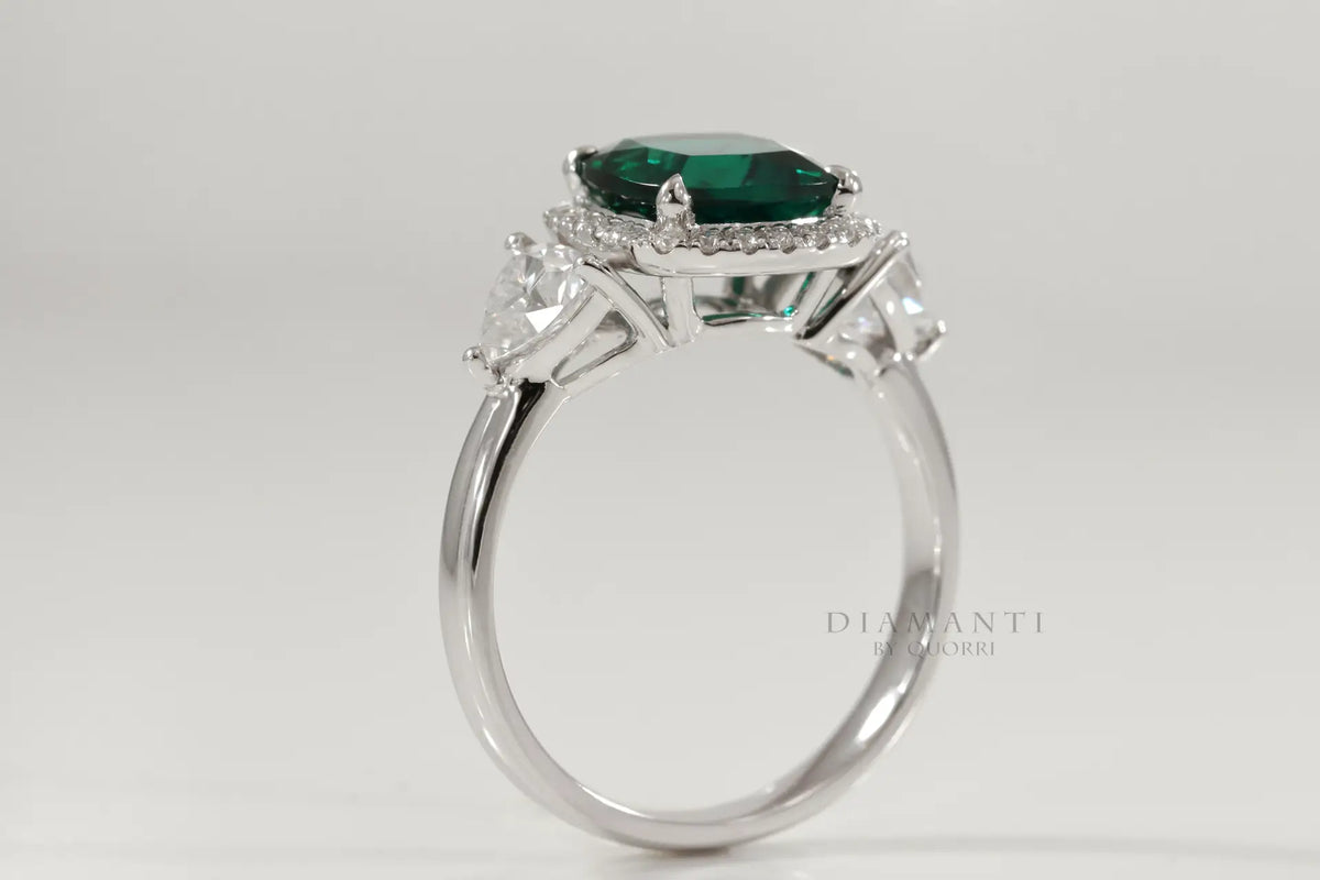affordable designer platinum three stone green emerald and trillion halo diamond engagement ring Canada