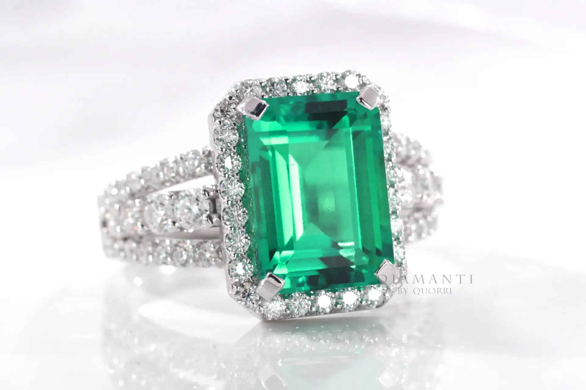 18k white gold custom lab grown synthetic Colombian or Zambian emerald halo engagement ring Quorri Canada
