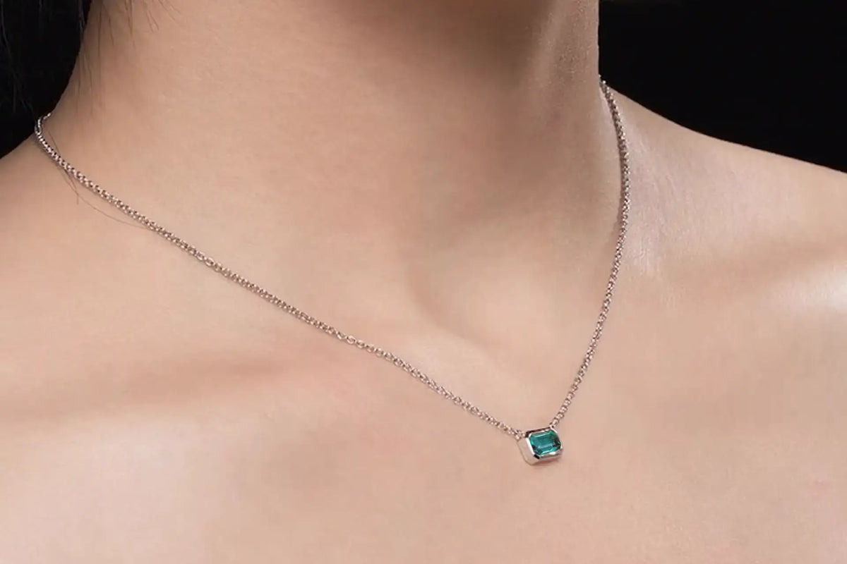 Canadian designer 14k white gold bezel set 1.50 carat lab grown green emerald pendant with built in chain at Quorri