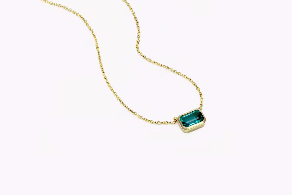 designer 14k yellow gold bezel set 1.50 carat lab grown green emerald pendant with built in gold chain at Quorri Canada