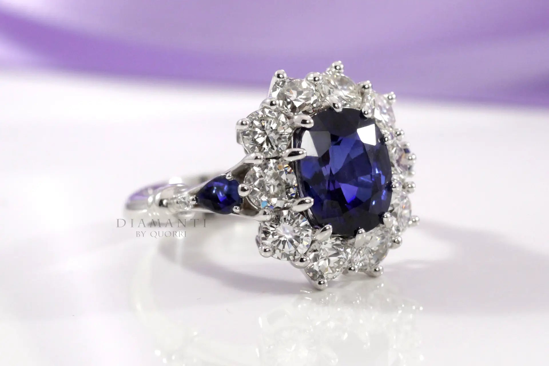 4 carat 18k white gold designer diamond halo with oval blue lab grown sapphire center and sides engagement ring Quorri