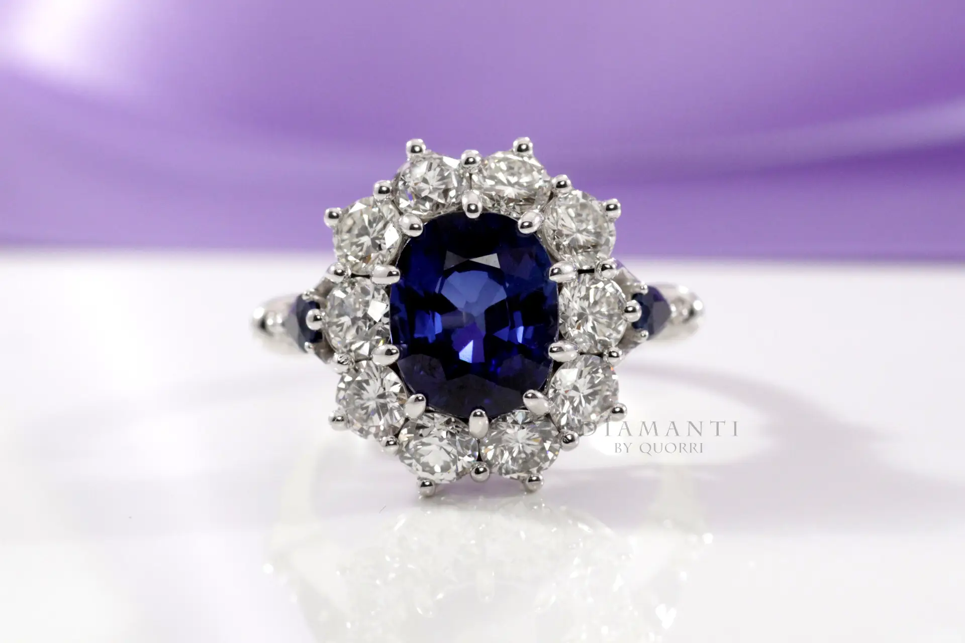 designer diamond halo with oval blue lab grown sapphire center and sides engagement ring Quorri