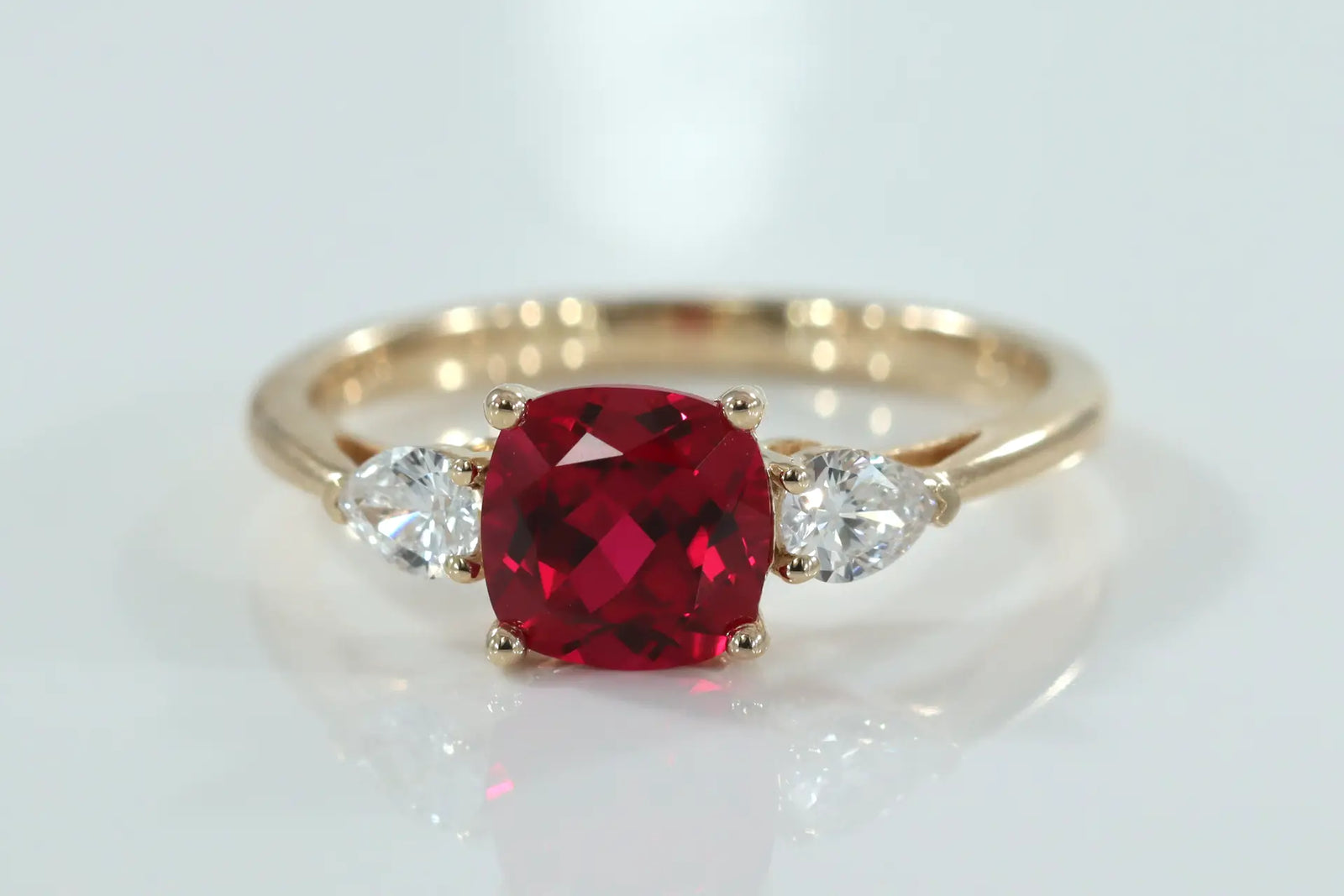 designer 14k yellow gold three stone 2 carat lab grown blood red cushion and pear lab diamond engagement ring Quorri Canada