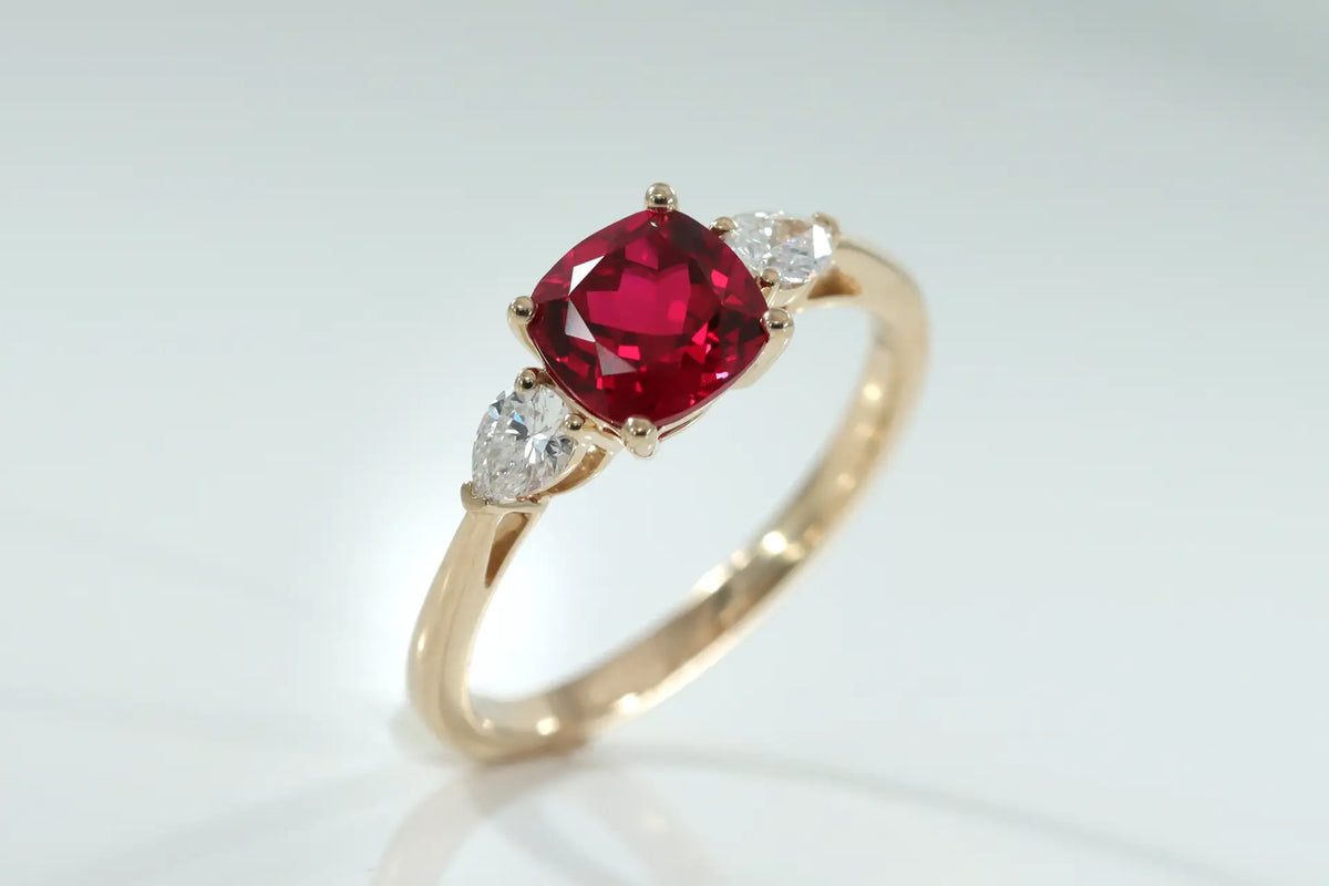 Canadian designer 14k yellow gold three stone 1.50 carat lab grown blood red cushion and .50ct.tw pear lab diamond engagement ring Quorri 