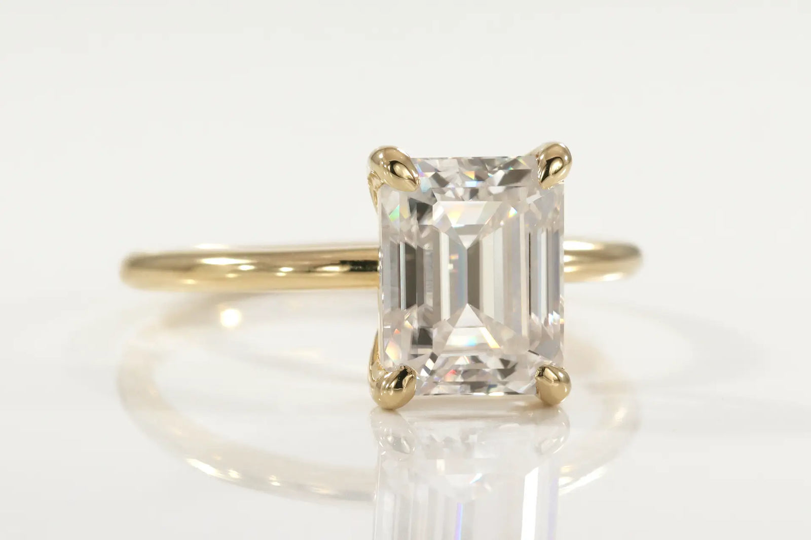 affordable 18k yellow gold claw prong 2 carat emerald cut lab diamond solitaire engagement ring Quorri