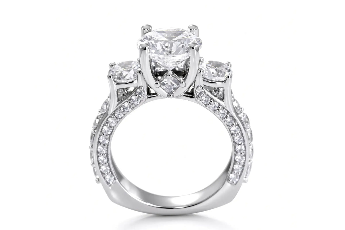 Three-stone diamond anniversary ring with a round-cut center stone and smaller diamonds along the shoulders features a euro bottom and blue sapphire princess accent