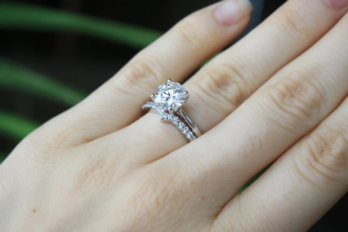 affordable crescent 18k white gold round brilliant lab diamond wedding band and 1.50 carat round solitaire ring set Quorri