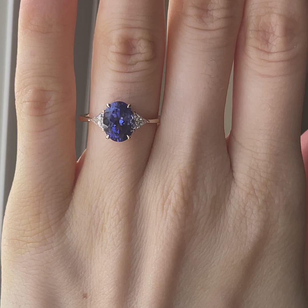 Canadian designer 14k yellow gold three stone engagement ring with 2 carat oval lab grown tanzanite center with lab grown diamond triangle sides on sale at Quorri