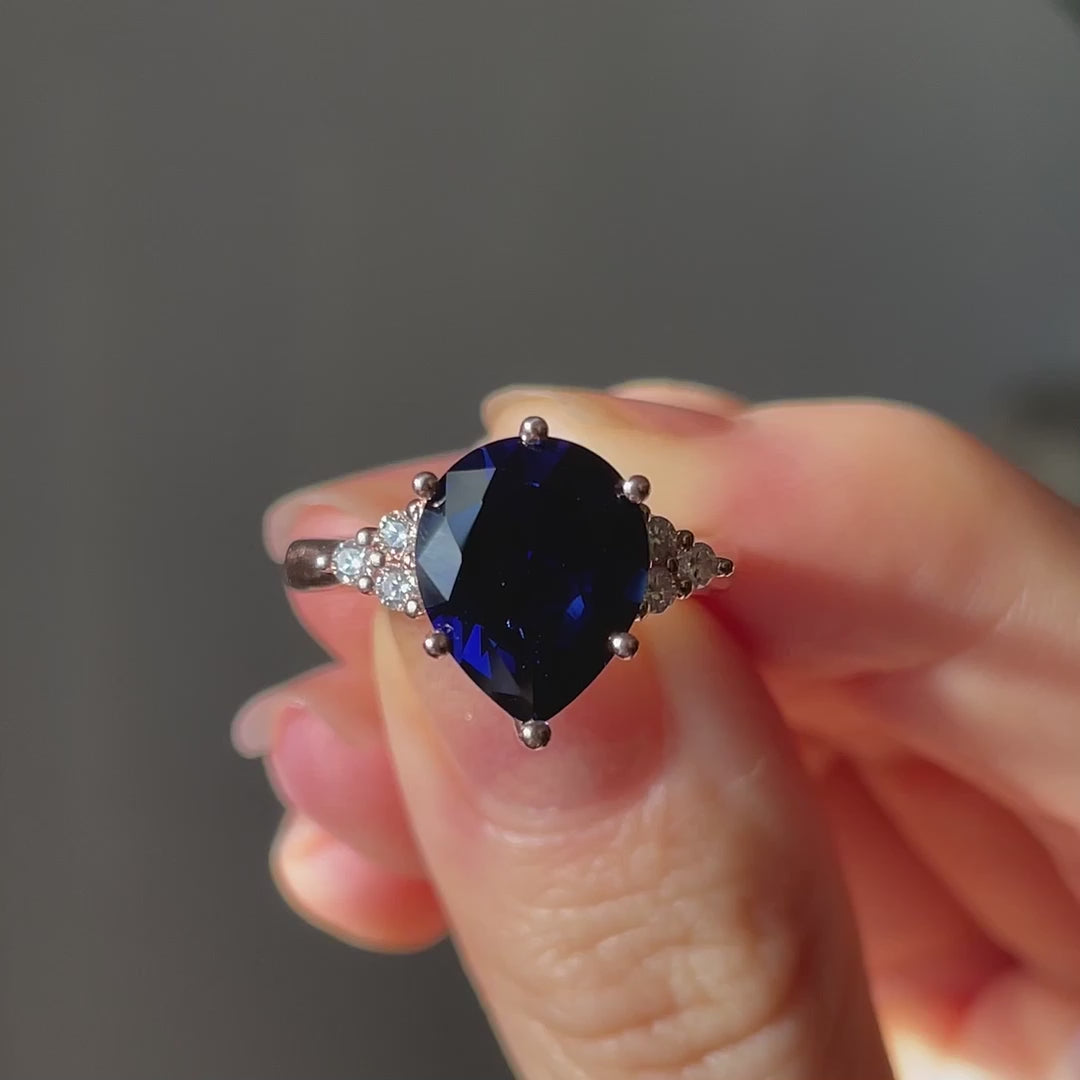 nature inspired rose gold 6 prong 3 carat pear cut lab grown blue sapphire engagement ring with round accent cluster sides Quorri Canada